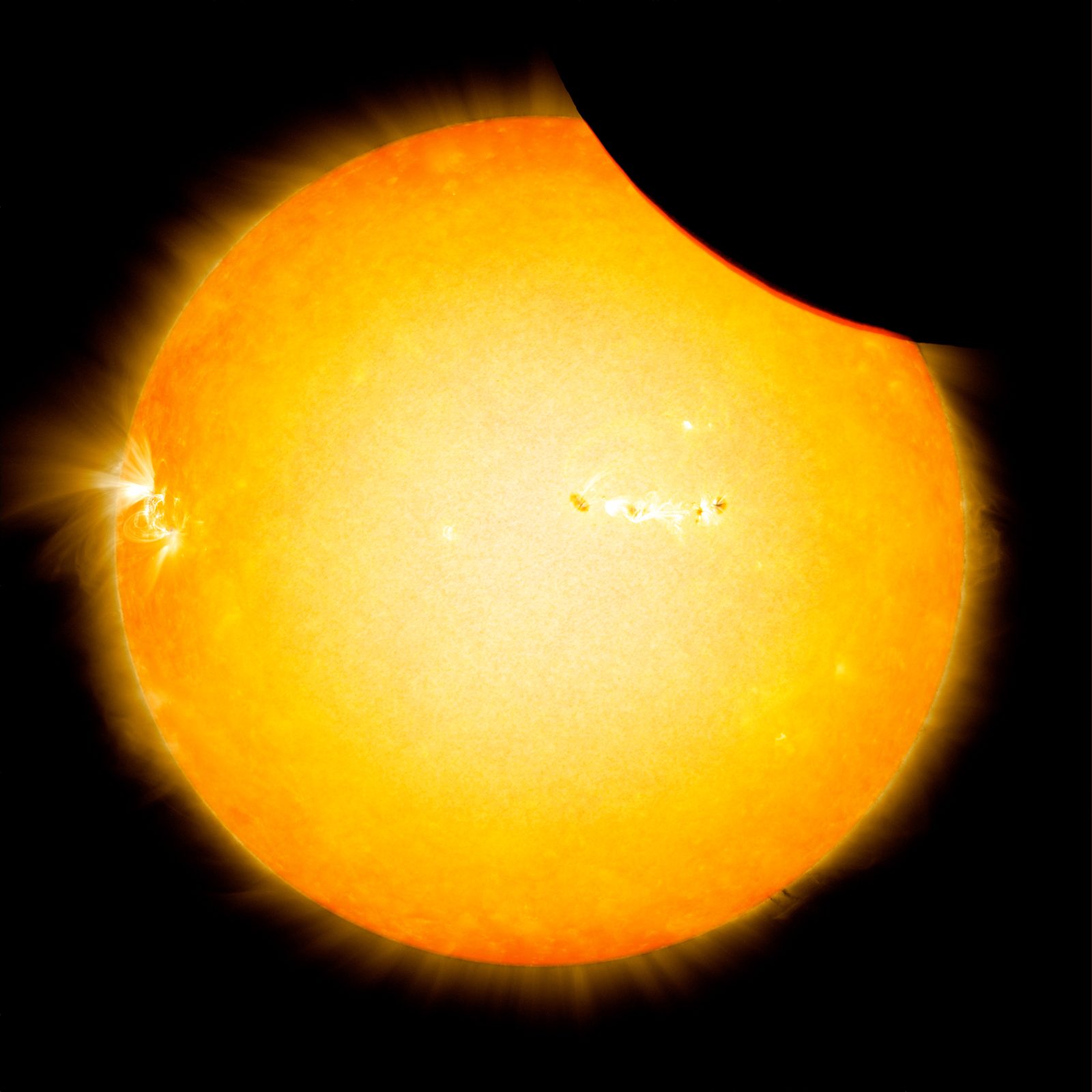 NASA SDO image of the Moon transiting across the Sun in blended visible and extreme ultraviolet light